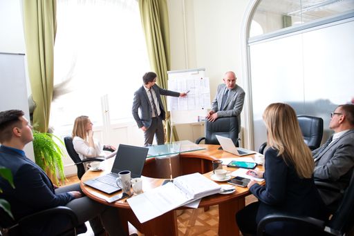 Successful business professionals presenting new project while working together with colleagues in the modern office