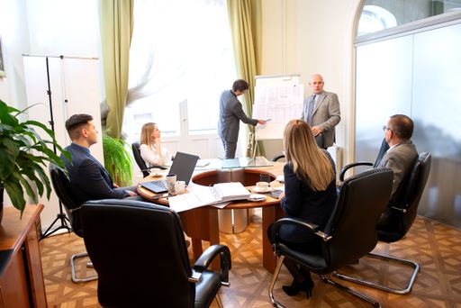 Successful business professionals presenting new project while working together with colleagues in the modern office