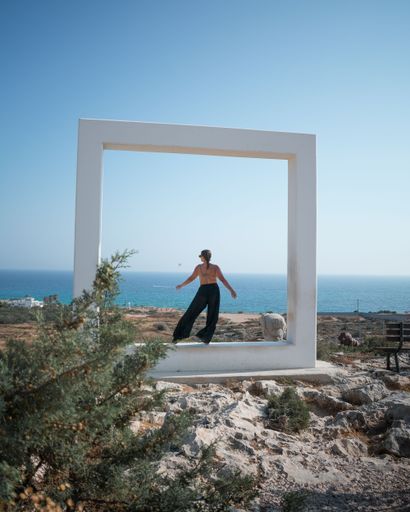 A woman in the middle of a giant white frame