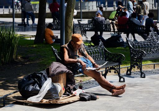 A Local poor old man reading the newspaper in the park during pandemic in Mexico City, Mexico