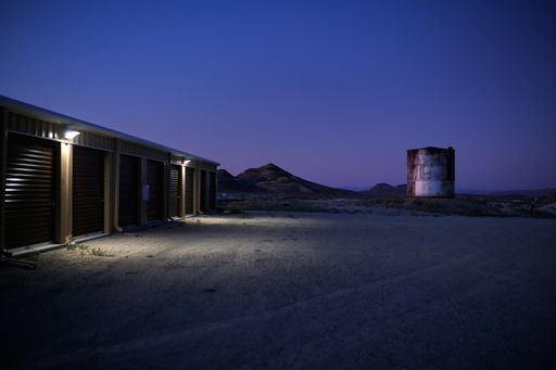 A beautiful shot of garages near each other with a purple sky in the background at sunset