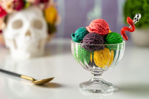 A selective focus shot of a glass cup full of colorful ice cream scoops - concept of restaurant