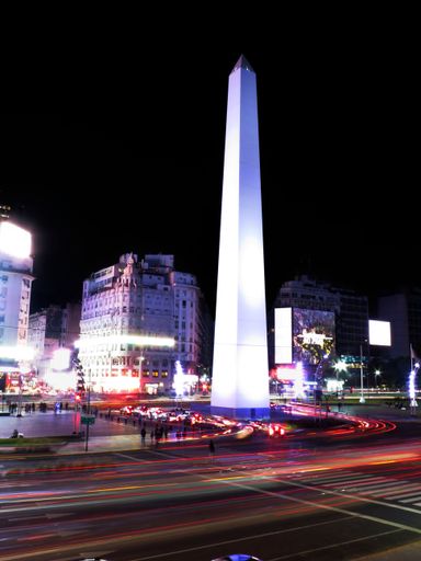 A vertical shot of the illuminated Obelisco at night in Buenos Aires