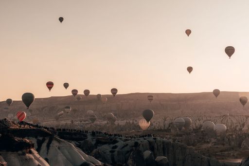 A beautiful scene of Balloons in the air over the city at sunset time