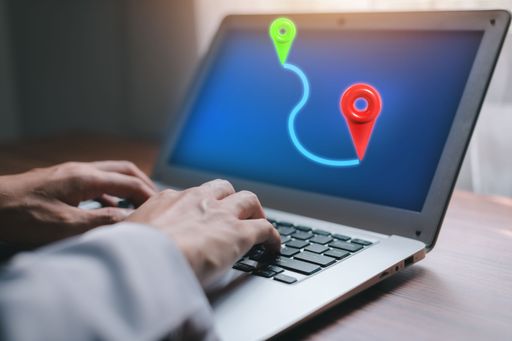 A locator mark of the map and location pin on the laptop