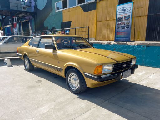Old beige sporty Ford Taunus coupe SP 1981 - 1984 in a warehouse yard. Sunny day. Expo Fierro 2022 classic car show. Copyspace