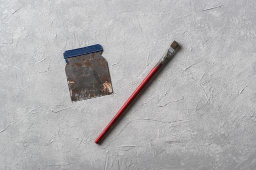 A close up shot of painting tools on  a grey textured background