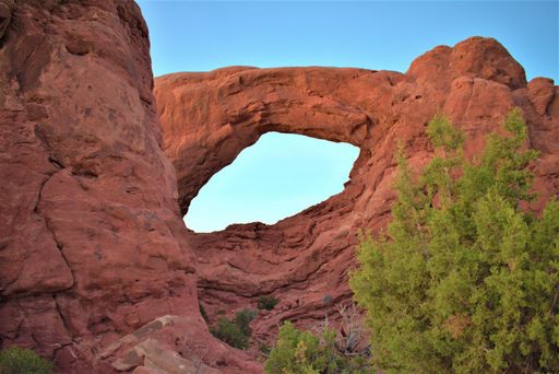 A closeup shot of the red rocks in form of arch in Utah desert under sunlight