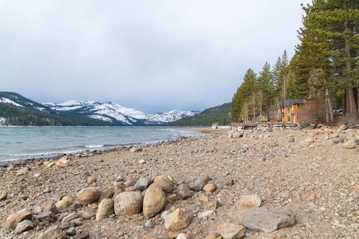 The Donner lake under the snow in winter, in the Nevada, with a chalet on the beach