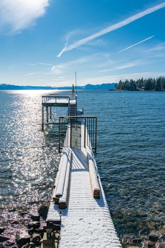 The Lake Tahoe, panorama of a mountain lake in winter, sunny day