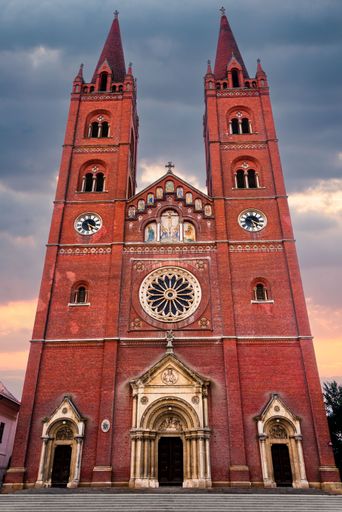 The vertical view of Dakovo Cathedral of St. Peter under the cloudy sunset sky in Croatia