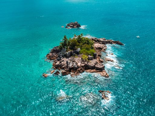 The small rocky island in Seychelles surrounded by turquoise water. The Indian Ocean,  East Africa.
