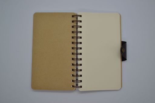 Top view of brown and cream color notebook recycled paper on white background