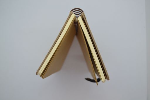 Top view of brown color notebook from recycled paper with on white background