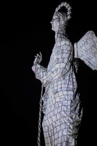 A vertical shot of the Loma El Panecillo during the night in  Quito, Ecuador