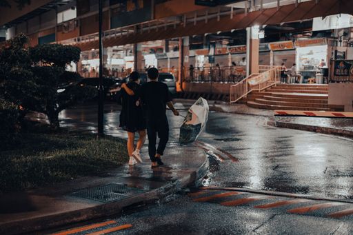 A couple walking in the rain with an umbrella