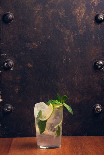 A vertical shot of alcoholic beverage on a wooden table