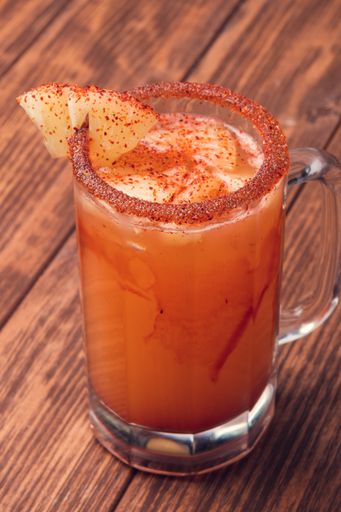A vertical shot of alcoholic beverage on a wooden table
