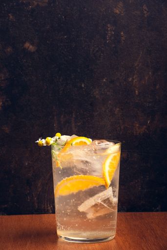 A vertical shot of alcoholic beverage on a wooden table