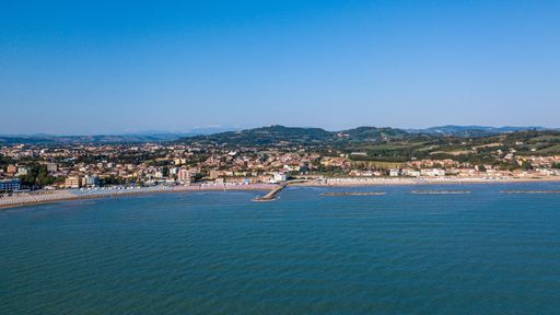 Italy, July 2022: aerial view of the city of Fano with its sea, the beaches, the port and the umbrellas
