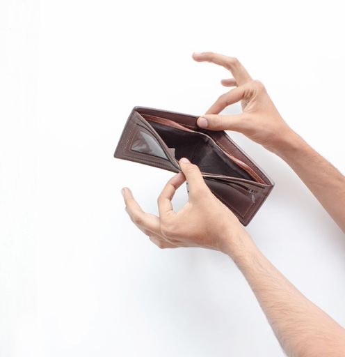 The hands of a man opening an empty wallet due to the economic crisis