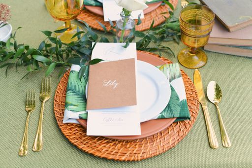 A card with the name Lily on a plate on a beautifully decorated table for an event