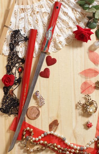 Vintage Lace Fan and Antique Flower Cutting Sword From Japan With Jewelry on Wood Table
