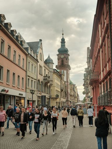 The pedestrians walking along Heidelberg's Hauptstrasse in Germany