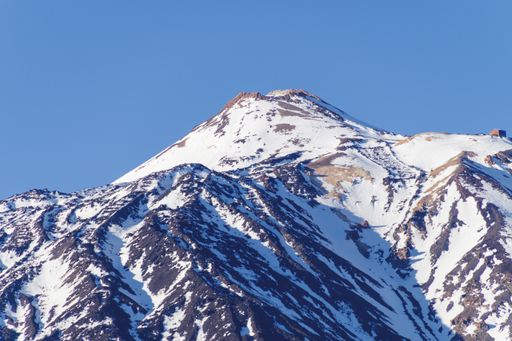 The beautiful mountain covered in snow under the blue sky