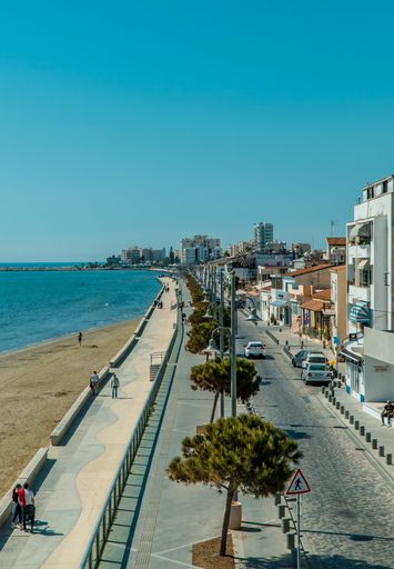 A vertical shot of a street and buildings on Finikoudes Beach from Larnaca Castle