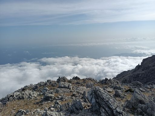 A beautiful view from the top of a rocky mountain near the clouds