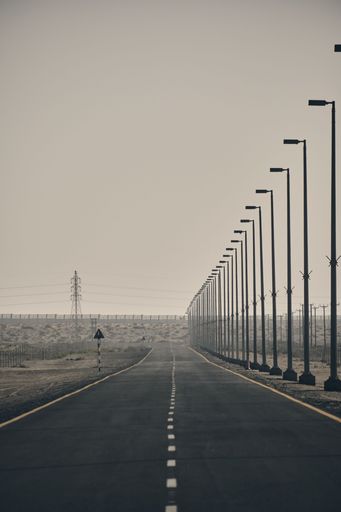 An empty highway with street lamps
