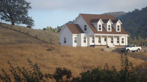 The view of the house on the hill and the car parked in the yard. San Diego, United States.