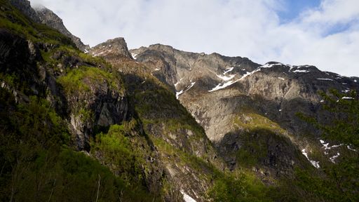 A mesmerizing view of mountains under a cloudy sky in Norway