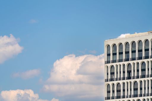 A facade of a modern building against a cloudy sky