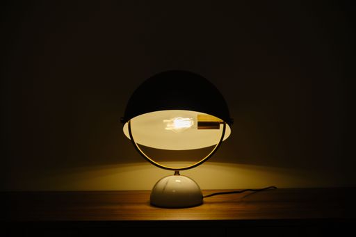 A closeup shot of a lampshade on a wooden surface
