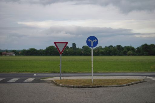 A closeup of street signs on a driving area