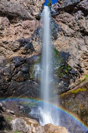 A scenic view of Treasure Falls in bright sunlight in Pagosa Springs, Colorado, Vertical shot