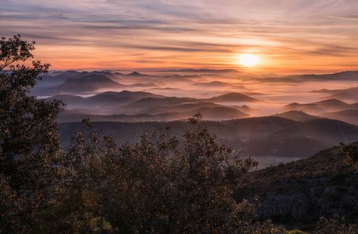 A beautiful shot of a hilly landscape during an amazing sunset