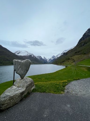 A calm lake with mountain and sky reflection