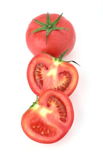 A closeup of ripe tomatoes isolated in white background