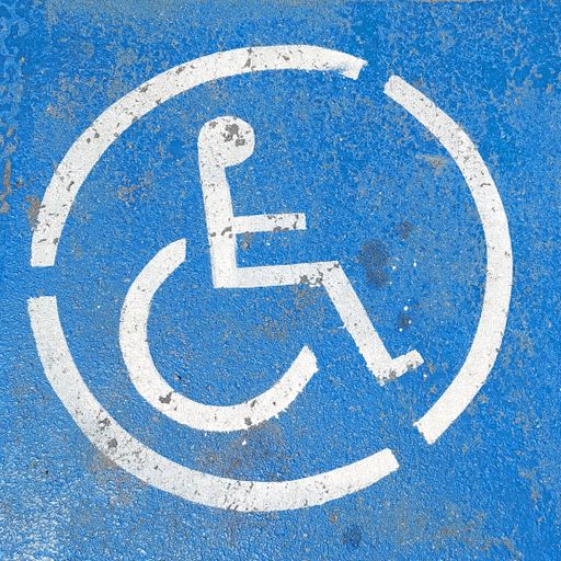 A parking space sign reserved for a person with a disability