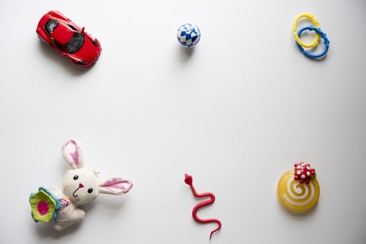 An overhead shot of toys on a white surface great for a background or a blog