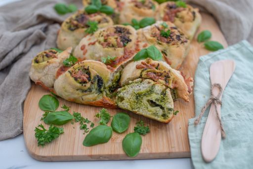 A home-made whole grain bread roll with wild garlic, bread, swirl, basil, pesto, sauce