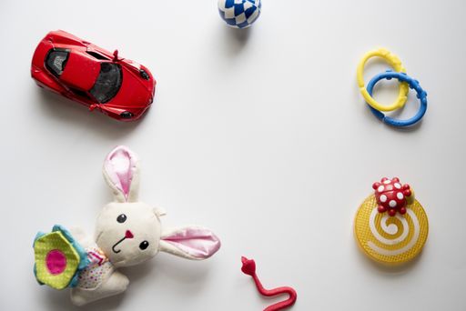 An overhead shot of a white surface with different toys