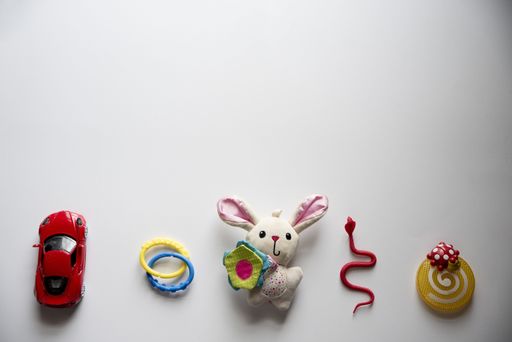 An overhead shot of a white surface with toys on the bottom great for a background