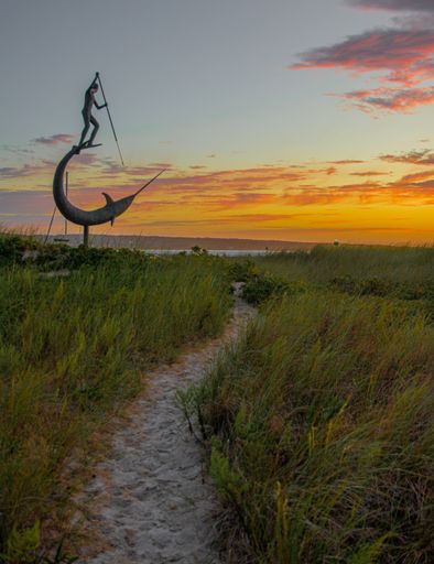 The sculpture of the harpooner during the sunset in the Marthas vineyard