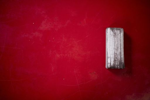 Closeup shot of a red board with a blackboard eraser