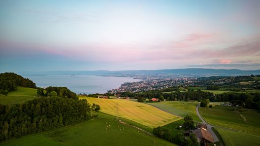 An aerial shot of the Lausanne cityscape next to Lake Geneva in Switzerland