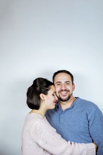 A vertical shot of a couple in love with a white background